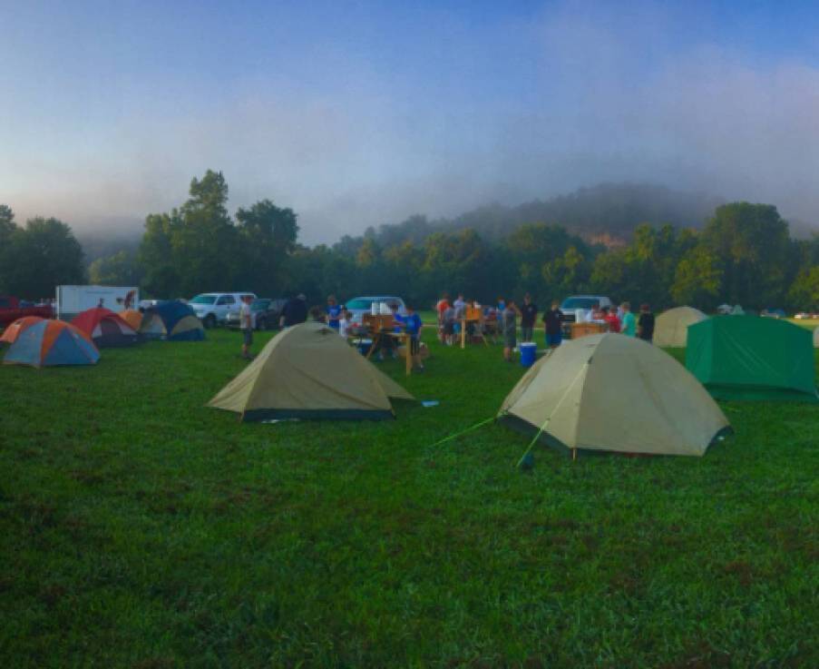 open field filled with tents